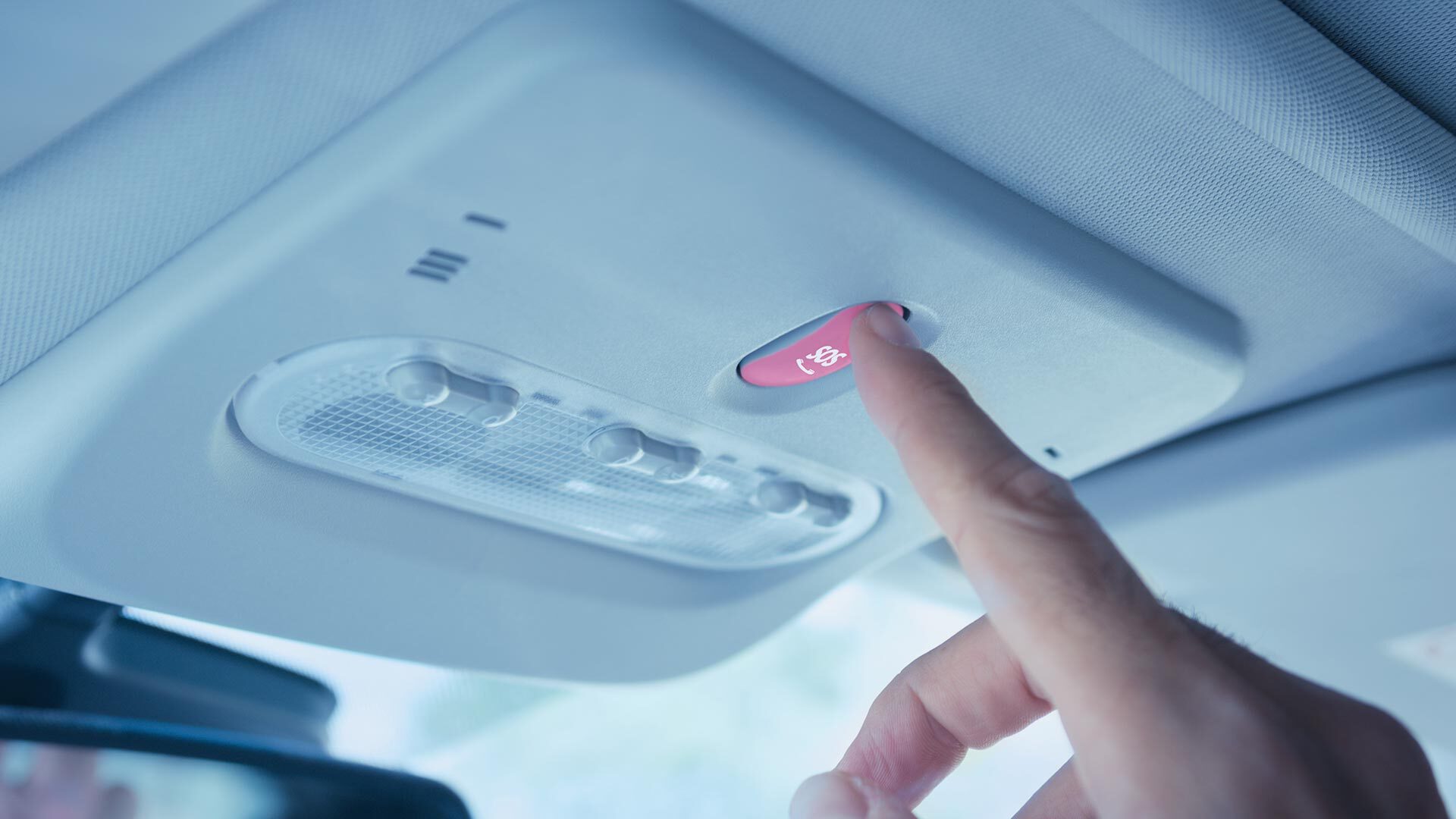 Hand pressing a car emergency button