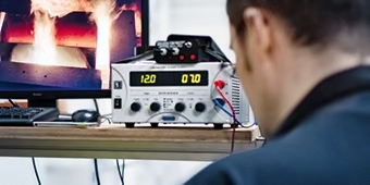 electrician in laboratory with measuring device